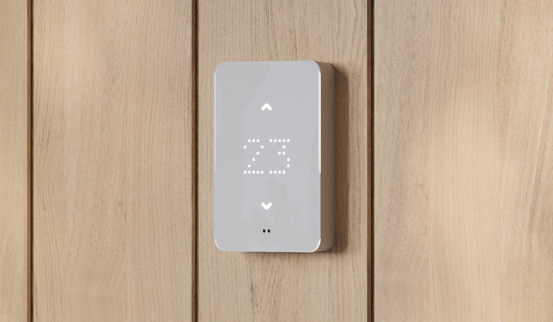 Mysa smart thermostat for electric baseboard heaters mounted on wood panelling